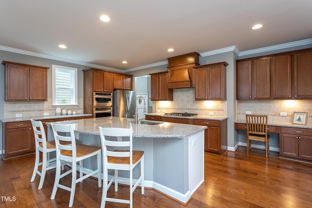 3913 Chapel Oak Dr, Apex, NC 27502 - kitchen with appliances with stainless steel finishes, tasteful backsplash, dark wood-style floors, ornamental molding, and a center island with sink