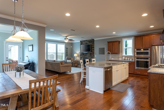 3913 Chapel Oak Dr, Apex, NC 27502 - kitchen with appliances with stainless steel finishes, ornamental molding, decorative backsplash, recessed lighting, and plenty of natural light