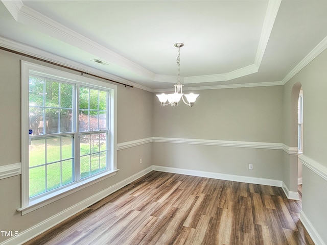 709 Pyracantha Dr, Holly Springs, NC 27540 - unfurnished room featuring wood finished floors, a chandelier, arched walkways, ornamental molding, and a raised ceiling