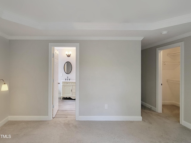 709 Pyracantha Dr, Holly Springs, NC 27540 - unfurnished bedroom featuring crown molding, light carpet, and a walk in closet