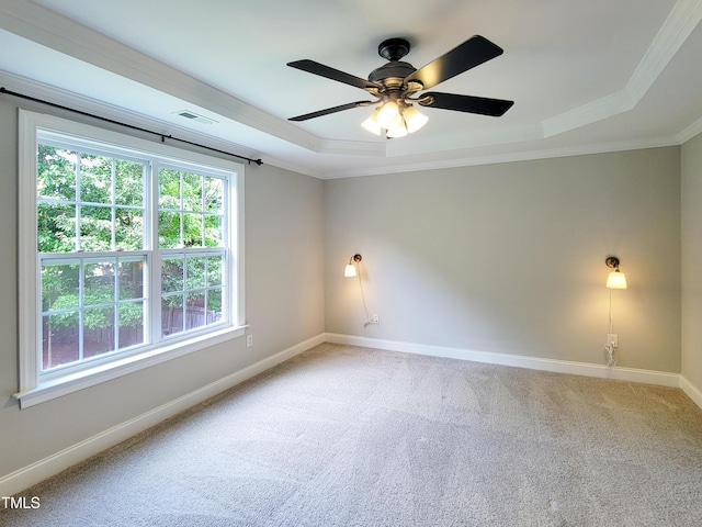 709 Pyracantha Dr, Holly Springs, NC 27540 - empty room featuring a tray ceiling, light carpet, ornamental molding, and ceiling fan