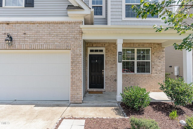 637 Stapleford Ln, Fuquay Varina, NC 27526 - entrance to property featuring brick siding, concrete driveway, and a porch