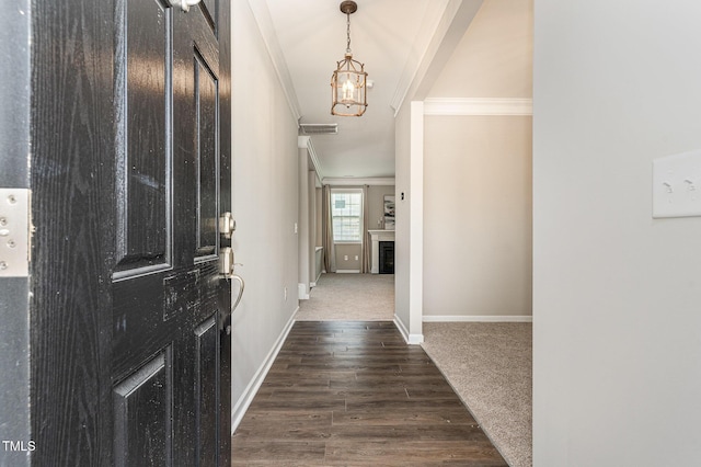 637 Stapleford Ln, Fuquay Varina, NC 27526 - entryway with ornamental molding, dark wood-type flooring, and a chandelier