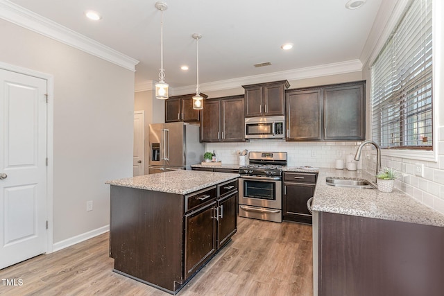 637 Stapleford Ln, Fuquay Varina, NC 27526 - kitchen with appliances with stainless steel finishes, dark brown cabinetry, decorative backsplash, light wood-type flooring, and ornamental molding