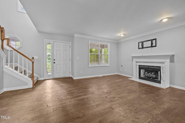 2763 Garland Ct, Creedmoor, NC 27522 - unfurnished living room with stairs, wood finished floors, plenty of natural light, a premium fireplace, and crown molding