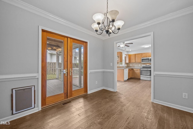 2763 Garland Ct, Creedmoor, NC 27522 - unfurnished dining area featuring a chandelier, french doors, wood finished floors, ornamental molding, and a ceiling fan