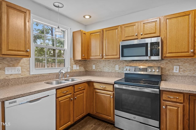 2763 Garland Ct, Creedmoor, NC 27522 - kitchen with appliances with stainless steel finishes, dark wood-type flooring, light countertops, decorative light fixtures, and backsplash