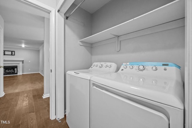 2763 Garland Ct, Creedmoor, NC 27522 - laundry room featuring dark wood-style floors, separate washer and dryer, and a fireplace