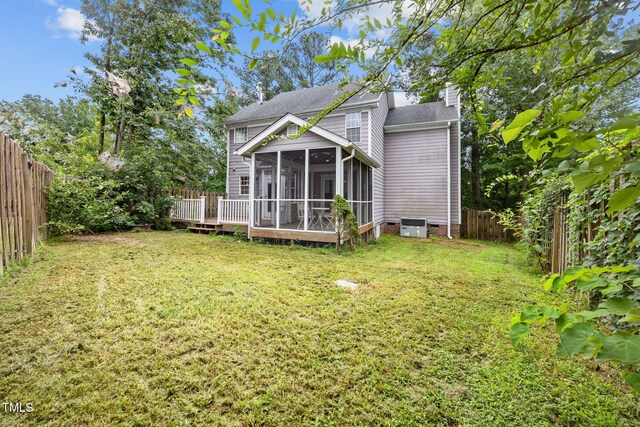 2763 Garland Ct, Creedmoor, NC 27522 - back of property with a chimney, a sunroom, a fenced backyard, a shingled roof, and a wooden deck