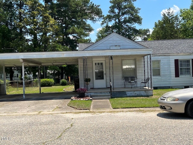904-906 Mckay Ave, Dunn, NC 28334 - view of front of property with covered porch, asphalt driveway, a shingled roof, and a front yard