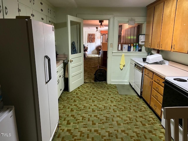 904-906 Mckay Ave, Dunn, NC 28334 - kitchen with white appliances, tile patterned floors, light countertops, and brown cabinetry