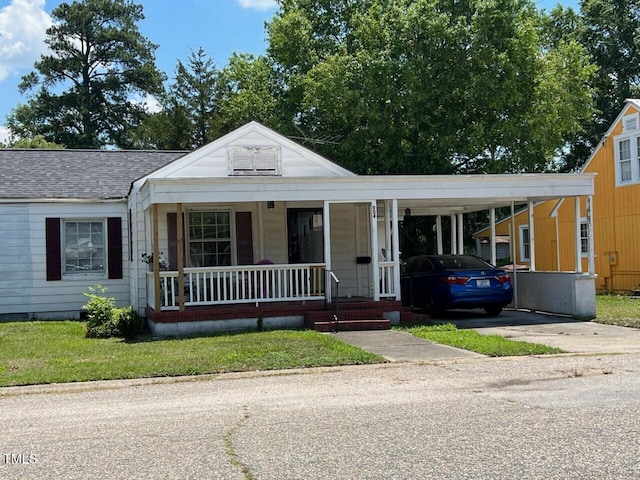 904-906 Mckay Ave, Dunn, NC 28334 - view of front of house with covered porch, driveway, a carport, and roof with shingles