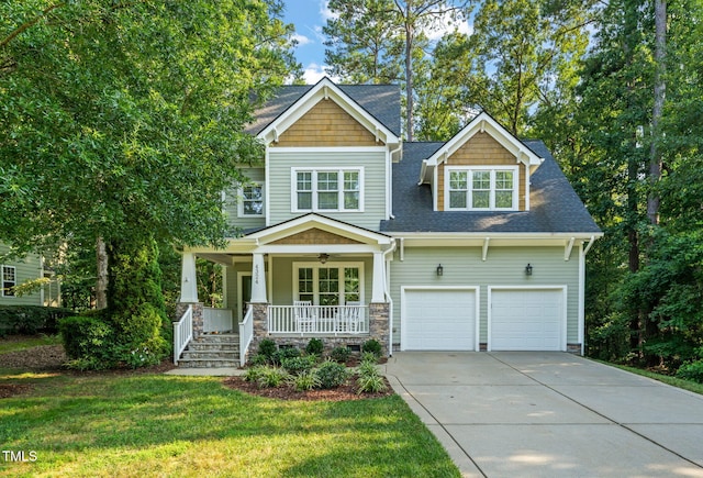 4324 Brighton Ridge Dr, Apex, NC 27539 - craftsman-style house with covered porch, driveway, a front yard, roof with shingles, and stone siding