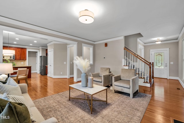 4324 Brighton Ridge Dr, Apex, NC 27539 - living room with stairway, ornamental molding, light wood-style floors, and recessed lighting