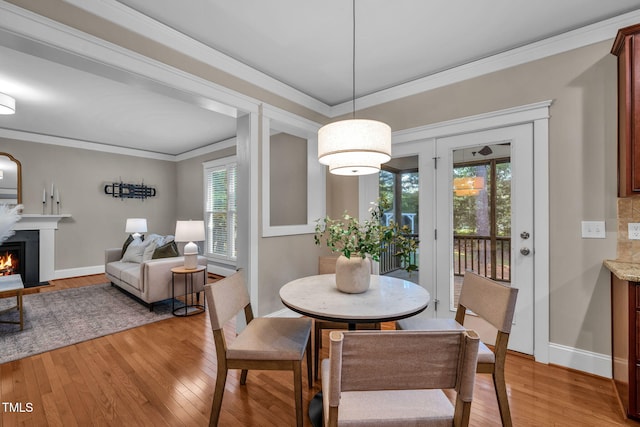 4324 Brighton Ridge Dr, Apex, NC 27539 - dining space with light wood-style flooring, a fireplace with flush hearth, and ornamental molding