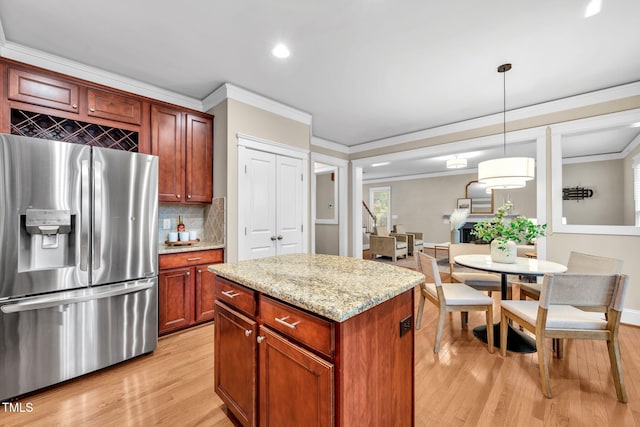 4324 Brighton Ridge Dr, Apex, NC 27539 - kitchen with stainless steel refrigerator with ice dispenser, crown molding, light wood-type flooring, backsplash, and hanging light fixtures