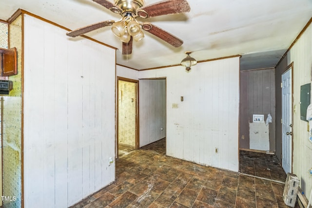 1141 Morgan Rd, Henderson, NC 27537 - unfurnished bedroom featuring wood walls, stone finish floors, and a ceiling fan