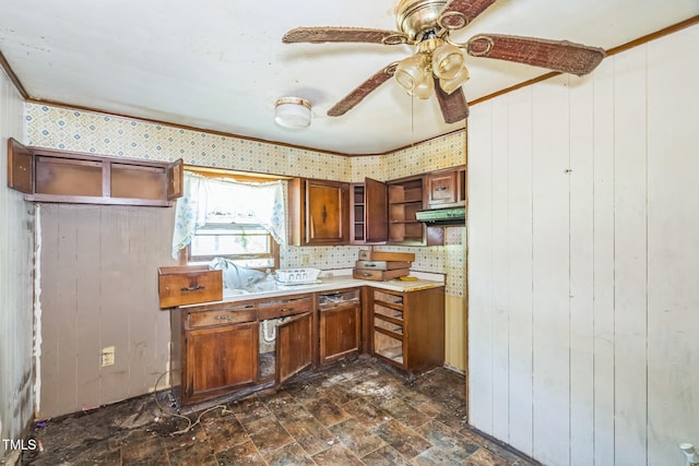 1141 Morgan Rd, Henderson, NC 27537 - kitchen with open shelves, brown cabinets, a ceiling fan, light countertops, and wood walls