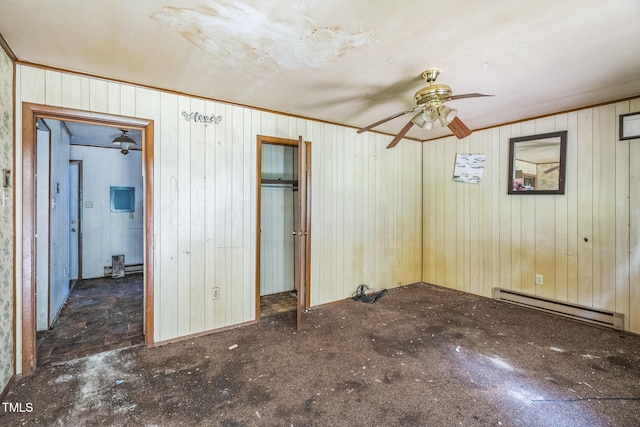 1141 Morgan Rd, Henderson, NC 27537 - unfurnished bedroom featuring a baseboard heating unit, wood walls, and a closet