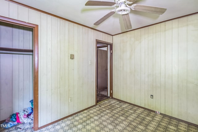 1141 Morgan Rd, Henderson, NC 27537 - unfurnished bedroom featuring tile patterned floors, wooden walls, ornamental molding, and ceiling fan