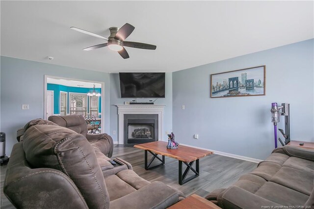 1214 Herring Gull Dr, Fayetteville, NC 28306 - living area with wood finished floors, ceiling fan, and a fireplace