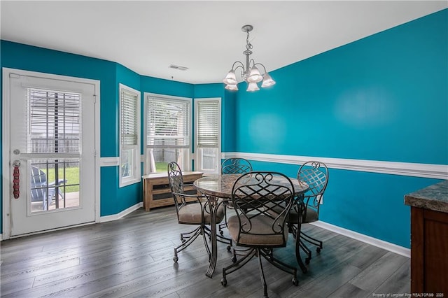 1214 Herring Gull Dr, Fayetteville, NC 28306 - dining space featuring a chandelier, wainscoting, healthy amount of natural light, and wood finished floors