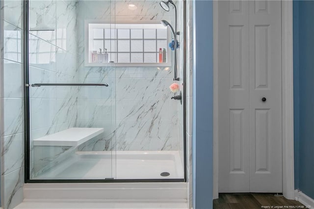 1214 Herring Gull Dr, Fayetteville, NC 28306 - bathroom featuring a closet, a marble finish shower, and wood finished floors