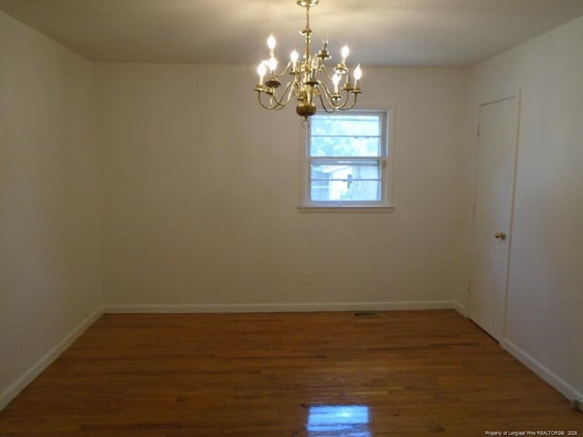 2631 Stonehaven Dr, Fayetteville, NC 28306 - empty room with wood finished floors and a chandelier