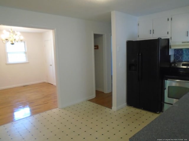 2631 Stonehaven Dr, Fayetteville, NC 28306 - kitchen with black fridge, stainless steel electric range, a chandelier, exhaust hood, and dark countertops
