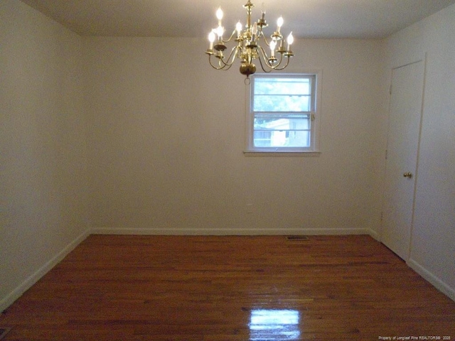2631 Stonehaven Dr, Fayetteville, NC 28306 - spare room featuring a chandelier and wood finished floors