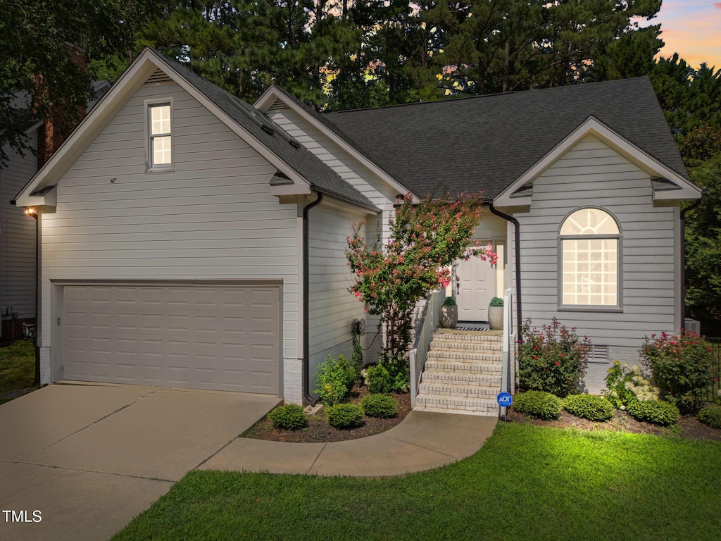 2104 Longwood Dr, Raleigh, NC 27612 - view of front facade featuring concrete driveway, an attached garage, and a shingled roof