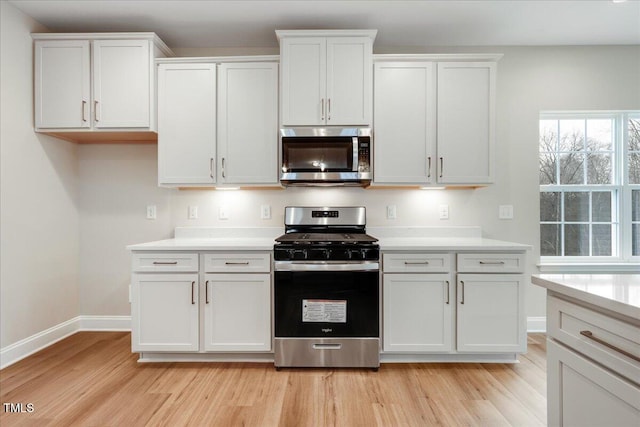 5486 Jaeger Dr Lot # 37, Graham, NC 27253 - kitchen featuring stainless steel appliances, light wood-style flooring, light countertops, and white cabinetry