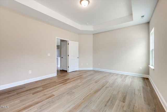 5486 Jaeger Dr Lot # 37, Graham, NC 27253 - spare room with light wood finished floors and a tray ceiling
