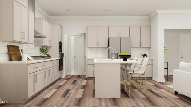 884 Cassa Clubhouse Way, Knightdale, NC 27545 - kitchen with freestanding refrigerator, backsplash, a center island with sink, light countertops, and light wood finished floors