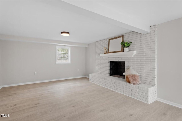 3408 Brentwood Rd, Raleigh, NC 27604 - unfurnished living room featuring wood finished floors, a fireplace, and beam ceiling