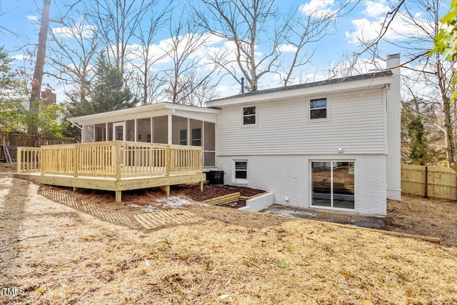 3408 Brentwood Rd, Raleigh, NC 27604 - rear view of house featuring a sunroom, a chimney, brick siding, and a wooden deck