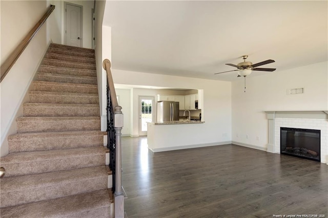 2677 NC Highway 20 W, Saint Pauls, NC 28384 - staircase with ceiling fan, wood finished floors, and a brick fireplace