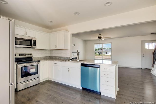 2677 NC Highway 20 W, Saint Pauls, NC 28384 - kitchen featuring appliances with stainless steel finishes, a peninsula, healthy amount of natural light, tasteful backsplash, and recessed lighting