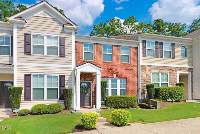 100 Stratford Lakes Dr # 322, Durham, NC 27713 - townhome / multi-family property with a front lawn and stone siding