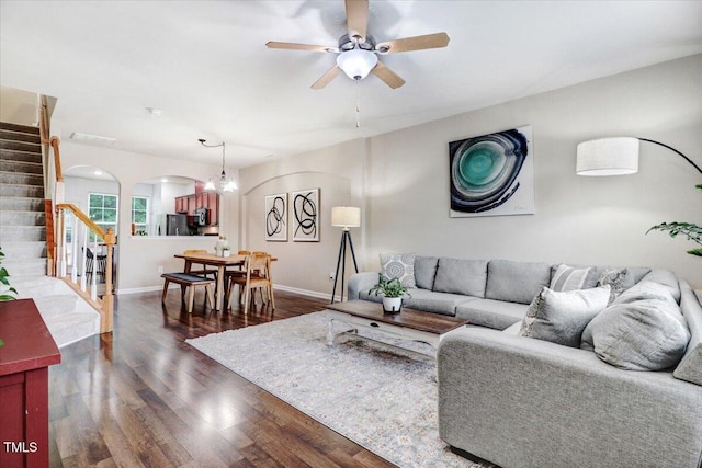 100 Stratford Lakes Dr # 322, Durham, NC 27713 - living room with stairway, arched walkways, dark wood-style flooring, a ceiling fan, and a chandelier