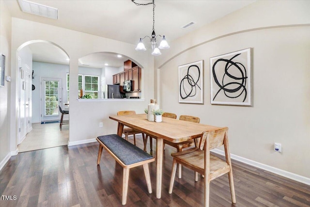 100 Stratford Lakes Dr # 322, Durham, NC 27713 - dining room featuring arched walkways, dark wood-style floors, and a chandelier