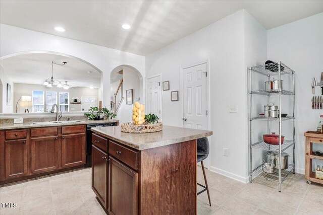 100 Stratford Lakes Dr # 322, Durham, NC 27713 - kitchen with a kitchen bar, arched walkways, a chandelier, light countertops, and black dishwasher