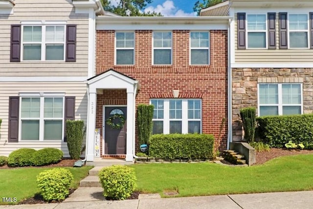 100 Stratford Lakes Dr # 322, Durham, NC 27713 - townhome / multi-family property with a front yard and stone siding