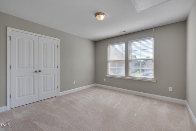 615 Fairway Dr, Mebane, NC 27302 - unfurnished bedroom featuring attic access, carpet, and a closet
