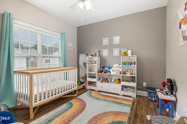 305 Maddux Dr, Pikeville, NC 27863 - bedroom with a nursery area, wood finished floors, and a ceiling fan