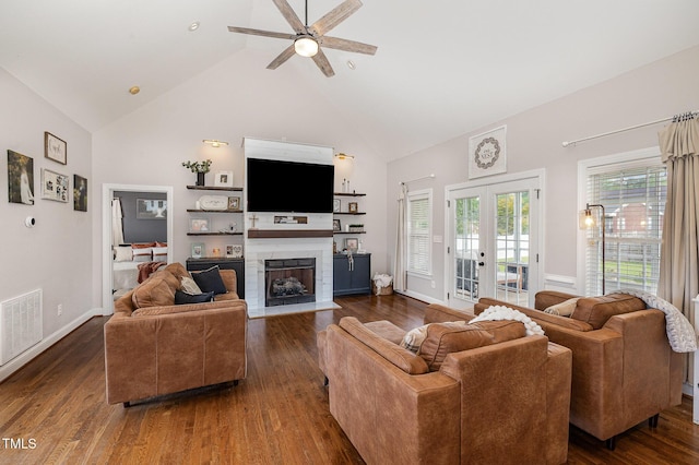 305 Maddux Dr, Pikeville, NC 27863 - living room featuring high vaulted ceiling, a fireplace with flush hearth, dark wood-type flooring, ceiling fan, and french doors