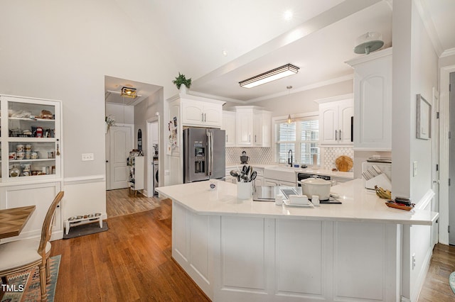 305 Maddux Dr, Pikeville, NC 27863 - kitchen with stainless steel fridge with ice dispenser, a peninsula, white cabinets, wood finished floors, and light countertops