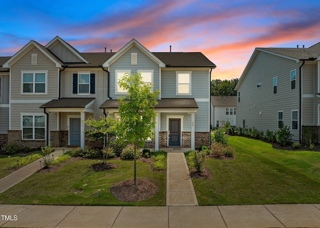348 Abbots Mill Dr, Raleigh, NC 27603 - view of front facade with brick siding, a front yard, and board and batten siding