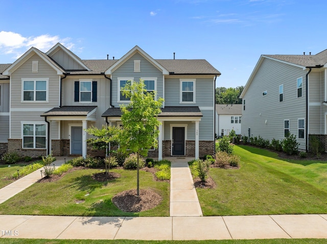 348 Abbots Mill Dr, Raleigh, NC 27603 - view of front of property featuring brick siding, a front yard, and board and batten siding