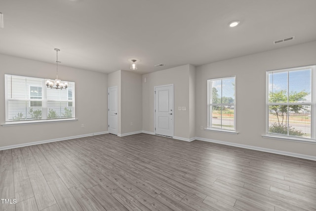 348 Abbots Mill Dr, Raleigh, NC 27603 - unfurnished living room featuring a chandelier and wood finished floors